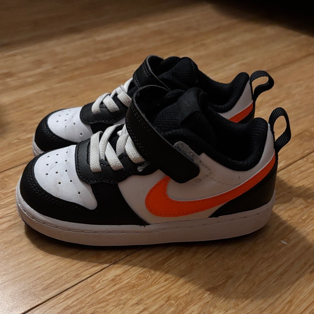 Nike Kids Black and White Sneakers with Orange Swoosh